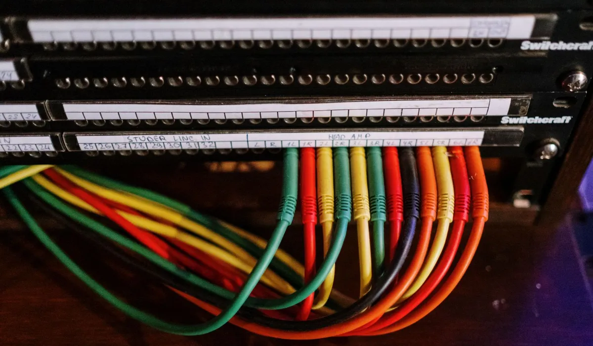 A patch panel of cables, illustrating API connections between exchanges and a bot platform