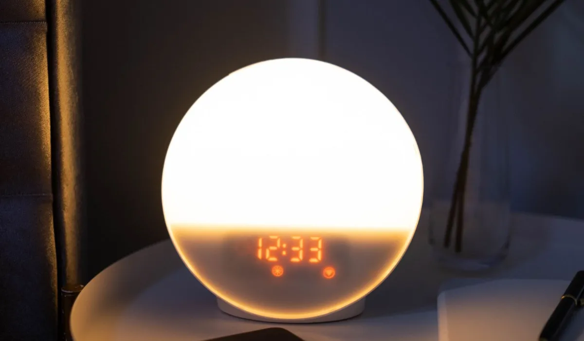 A phone on a nightstand showing a chat interface, late at night