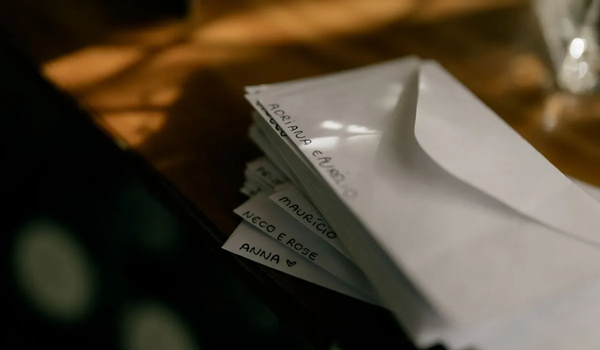 A stack of unopened envelopes on a desk